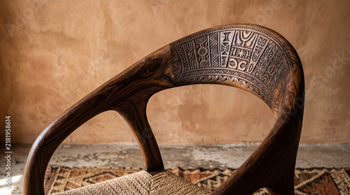 wooden chair backrest with ethnic tribal carved ornament detail