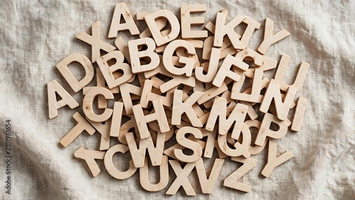 Wooden Alphabet Letters Jumbled on Linen Fabric