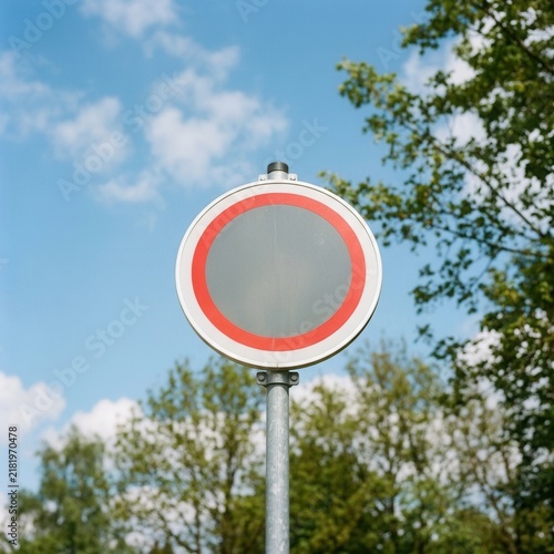 Blank Circular Road Sign Against A Bright Sky