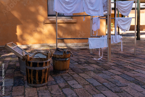Konstfotografi Historical laundry display with wooden buckets, washboard, and drying rack