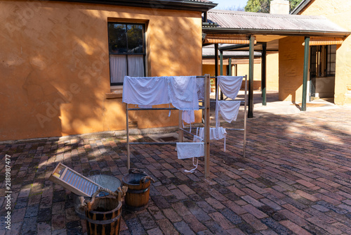 Canvastavla Historical laundry display with wooden buckets, washboard, and drying rack