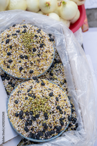 Canvastavla Mixed healthy multigrain cereals with black beans and mung beans heaped in bowls at traditional Korean outdoor market