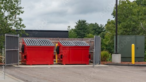 large red commercial dumpster for trash and recycling