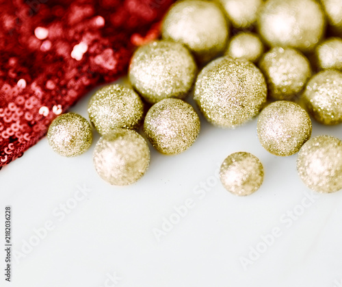 фотографія Glitter gold baubles and red sequin textile