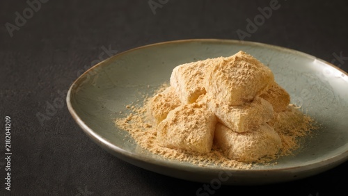 Traditional Korean Injeolmi Rice Cakes with Soybean Powder in Elegant Rustic Setting