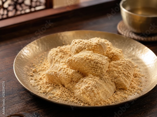 Traditional Korean Injeolmi Rice Cakes with Soybean Powder in Elegant Rustic Setting