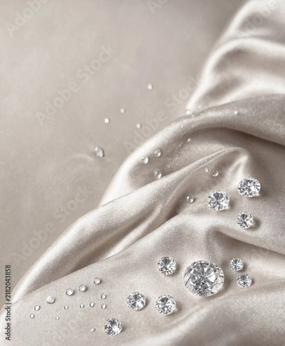 Sparkling diamonds and dewdrops on lxurious silk fabric background