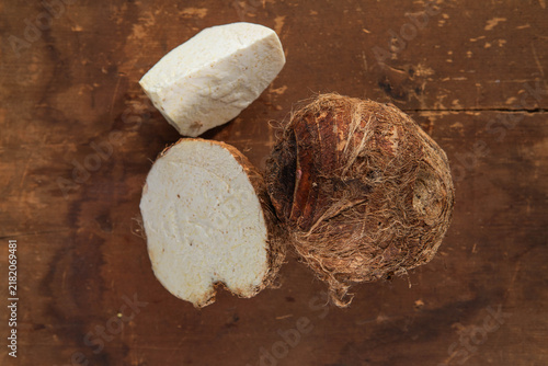 Fotografie Fresh Taro Root Ion wooden table