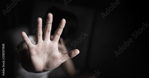 Woman raising hand to stop abuse, promoting women's rights, safety and equality for International Women's Day and raising awareness of human trafficking.
