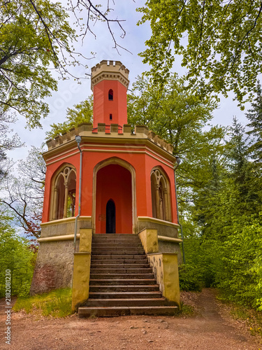 Photography Colorful building located in Karlovy Vary, Czechia surrounded by trees