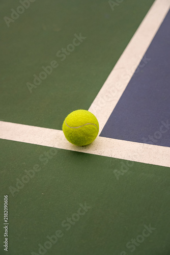 Konstfotografi Close-up of yellow tennis ball falling on the white line of the court