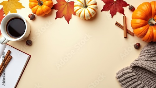 Cozy autumn flat lay with pumpkins, warm knitted blankets, coffee, maple leaves and cinnamon on a light background. Seasonal fall composition with copy space for text, banners and designs