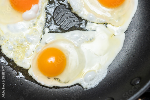 close up fried eggs in a  pan