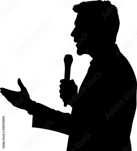 Silhouette of a Man Speaking into a Microphone and Gesturing with One Hand during a Public Speech or Presentation