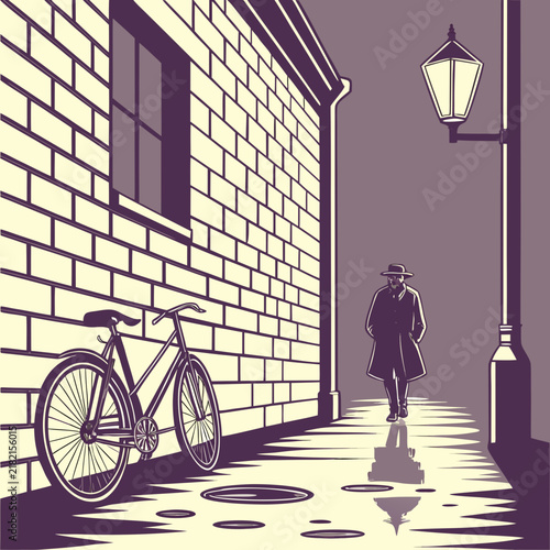 Man walking alone on a sidewalk near a brick wall with a bicycle at night