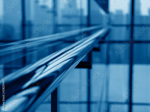 Принти на полотні Refined tubular handrail extending into indistinct backdrop with light reflectio