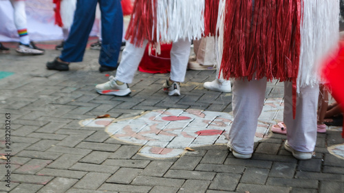 Cuadro en lienzo People in Traditional Red and White Costumes Walking on Street with Tiger Chalk