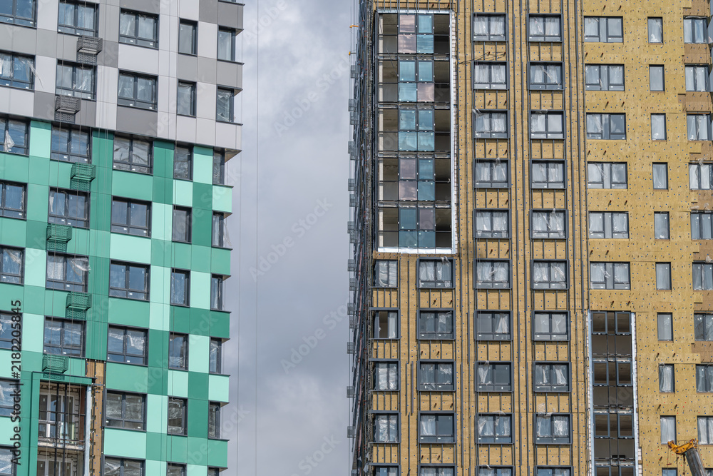 Fototapeta premium Modern architecture shines in an urban landscape with colorful buildings standing tall against a cloudy sky
