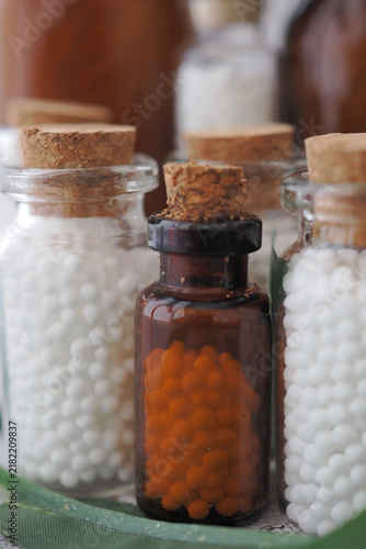 Konstfotografi Homeopathic Remedy Glass Bottles With Orange and White Globules Close-Up Display