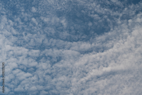 Cuadro en lienzo Soft wisps of clouds dance gracefully in an endless blue sky capturing the seren