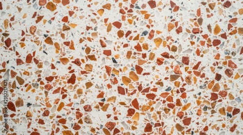 Terrazzo texture surface featuring colorful stone chips in a neutral mortar base for modern interior design and architectural background.