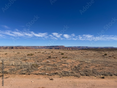 Canvastavla Flat desert scrubland with a distant mesa in the American Southwest