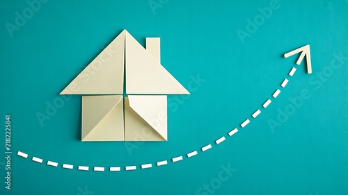 Origami house with upward arrow representing growth success and progress