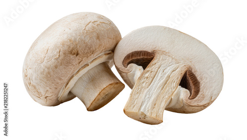 Фотография Two fresh white button mushrooms one halved showing gills, isolated on transpare