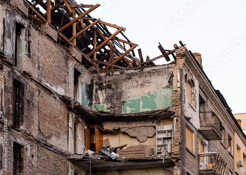 A severely damaged building on Dehtiarivska Street in Kyiv after a Russian missile attack, showing a collapsed roof and exposed interior

