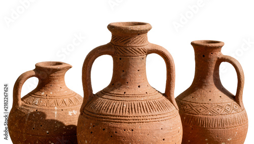 фотографія Three rustic terracotta amphorae with decorative carvings, isolated on transpare