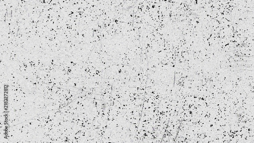 Granular grey concrete surface with speckled texture during bright daylight with subtle shadow accents