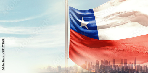 Fotografía Chile national flag wavering in beautiful clouds with building skyline
