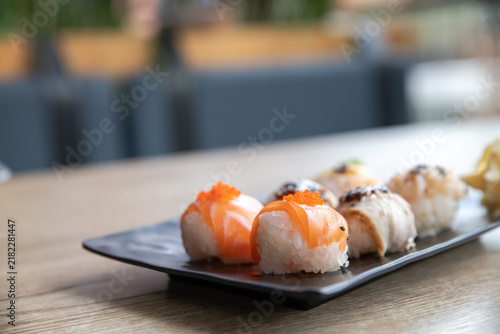 Obraz na plátne Temarizushi or Japanese rice balls served on the black plate in the restaurant Temari zushi with shrimp, crab, salmon, eel