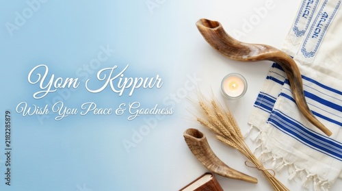 Yom kippur greeting card with shofar horns, prayer shawl, and wheat stalks on a blue and grey background