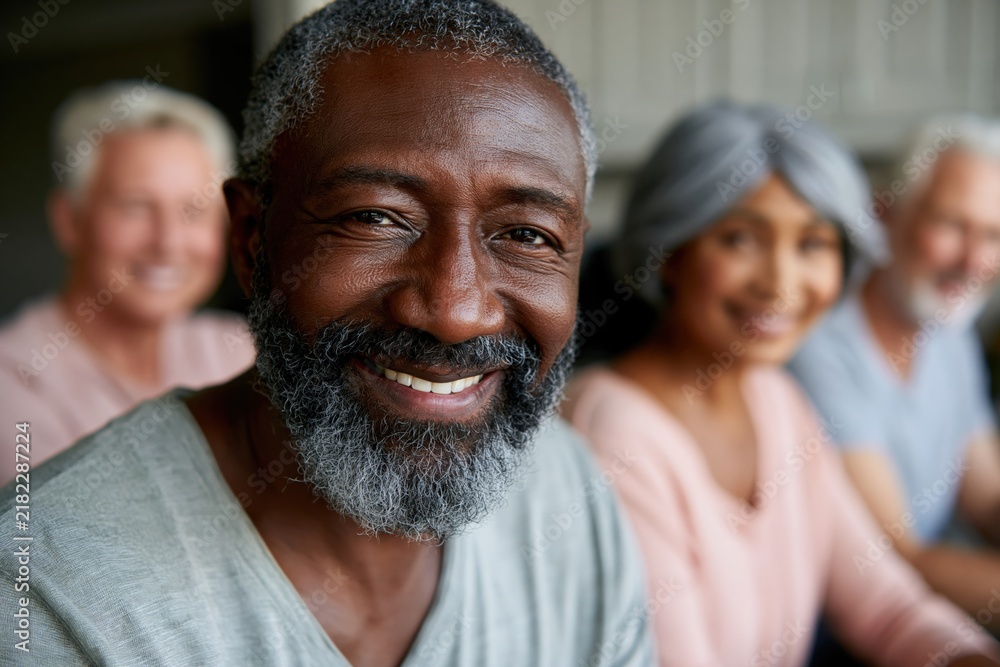 Obraz premium Closeup smiling mature black man with diverse seniors portrait for community healthcare banner background and wellness design