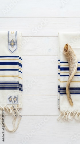Young woman sitting on a blue and white striped beach chair wearing a green towel wraps and enjoying the summer sun