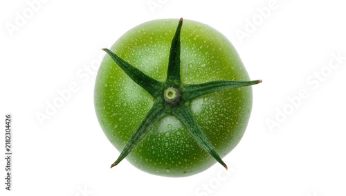 Single unripe green tomato with water droplets, isolated on transparent background