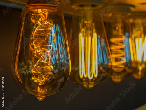 Close-up of decorative retro style warm glowing light bulbs hanging in a row