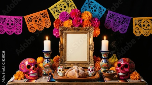 A traditional colorful Day of the Dead altar featuring a golden picture frame, marigold flowers, painted sugar skulls, and bread on a festive table with papel picado banners against a black background