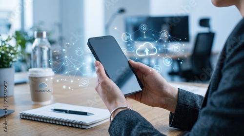 Business person holding smartphone with futuristic holographic cloud computing interface icons floating above screen, digital transformation, data storage upload symbol