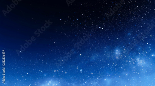 深い青の夜空に光の粒が広がる幻想的な背景