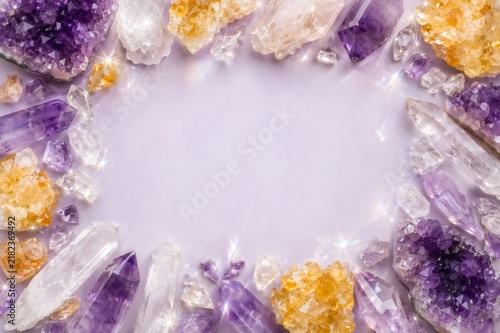 Sparkling natural amethyst, citrine, and clear quartz crystals surround an empty light purple background, creating a serene and mystical healing energy frame
