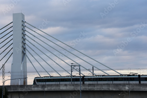 View of Sydney Metro train crossing cable stayed bridge at Rouse Hill