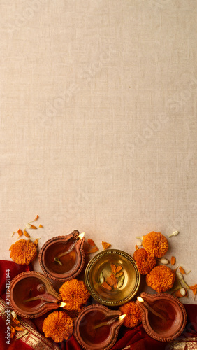 Diwali oil lamps and marigold flowers vertical banner with copy space