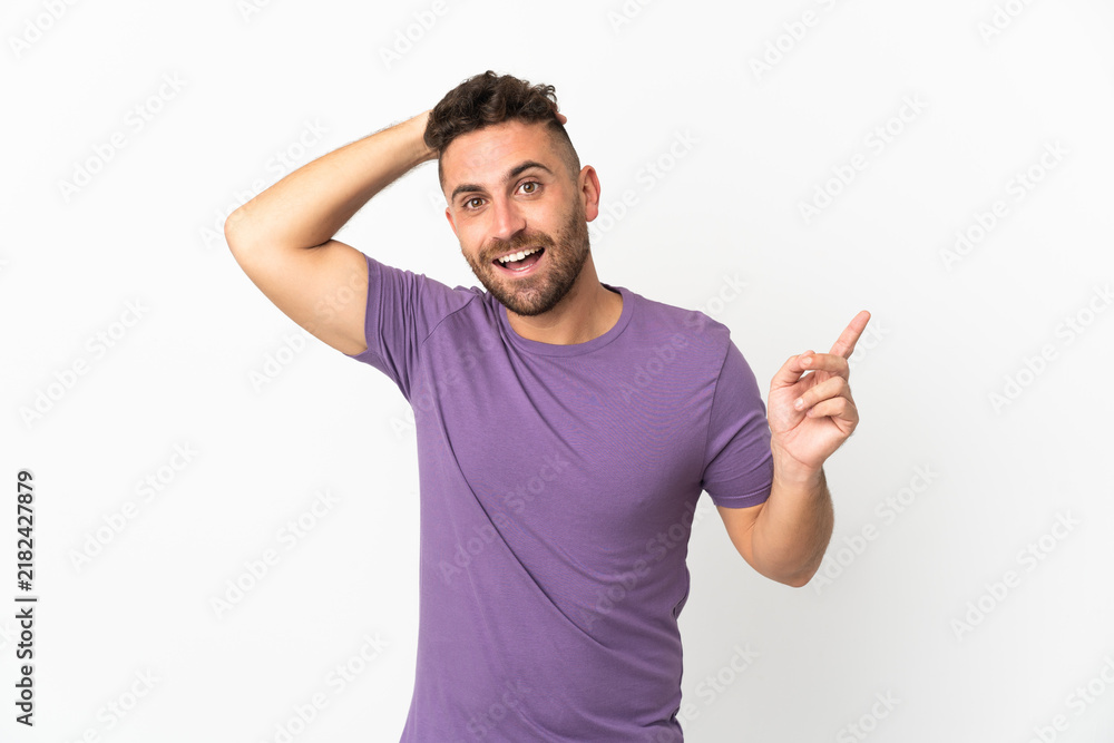 Fototapeta premium Caucasian man isolated on white background surprised and pointing finger to the side