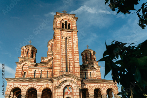 Fotografía Saint Mark Church rises against a blue sky in central Belgrade Serbia