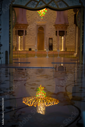 Bright and colourful lamp shining on a reflected marble floor in a religious temple Mosque in Abu Dhabi