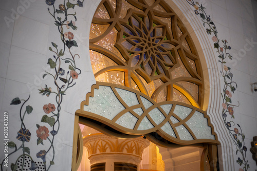 Stained glass detail on the beautiful Grand Mosque building in Abu Dhabi with beautiful flower shape patterns and geometric textures