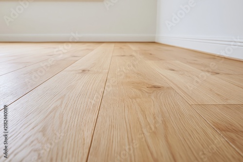 The wooden floor stretching across a bright minimalist interior with natural grain