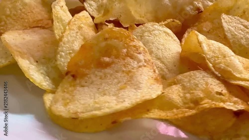 Crispy golden potato chips, crunchy salted snack food, close up of fried potato slices for junk food advertising